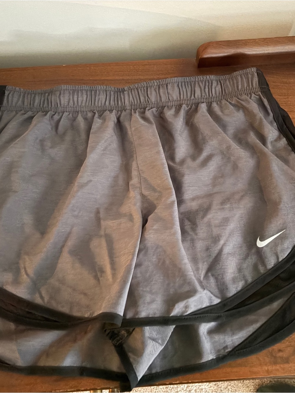 Nike Women's Gray Athletic Shorts with Black Trim and White Swoosh